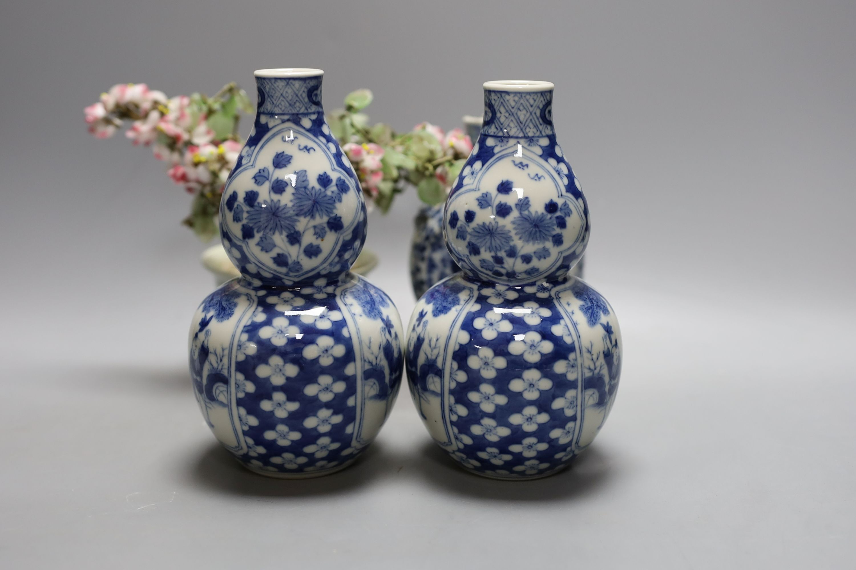 A pair of Chinese blue and white double gourd vases, similar moonflask and flower ornament 18cm